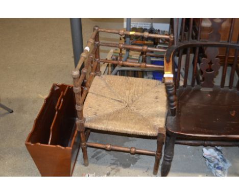 A string seated corner chair with bobbin turned decoration; and a mahogany Canterbury&nbsp;