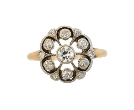 An early 20th century diamond cluster ring, the old cut diamond collet within a similarly cut diamond openwork surround, esti