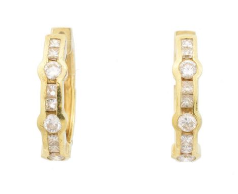 A pair of 18ct gold diamond hoop earrings, each designed as a brilliant and square cut diamond line, with hinged reverse, imp