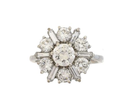 A diamond cluster ring, the brilliant cut diamond within a brilliant and baguette cut diamond surround, estimated total diamo
