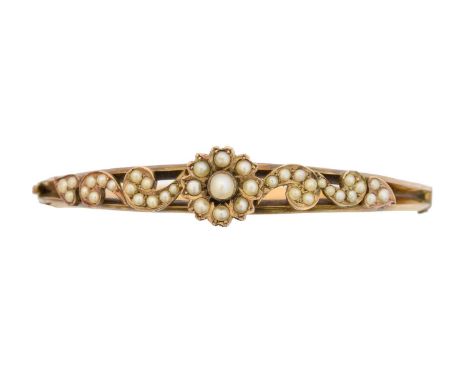 An early 20th century split pearl hinged bangle, of foliate design with scrolling sides and plain reverse, inner diameter 5.8