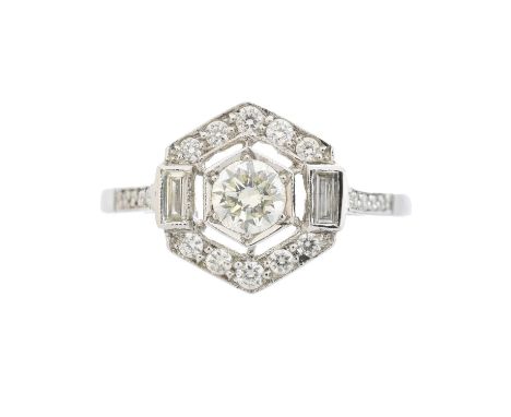A diamond cluster ring, of geometric design, the circular cut diamond within a vari cut diamond hexagonal surround and brilli