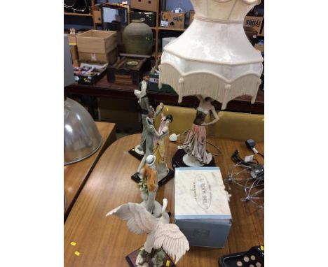 A collection of 'Armani' figures and a lamp
