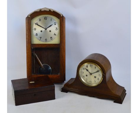 A mahogany dome topped mantel clock, the silvered dial set with Arabic numerals, width 41cm (plinth af), an oak wall clock wi