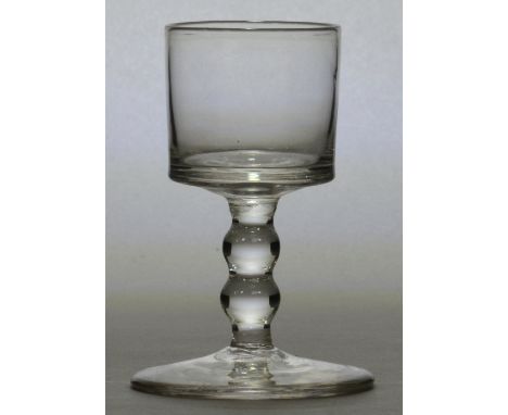 An unusual mid 18th century liqueur glass, with bucket bowl above unusual double bobbin turned stem and circular foot, Englis