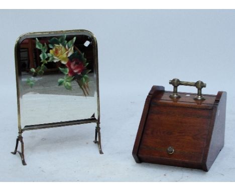 A late Victorian oak coal scuttle with sloped front and with fluted brass handle, height 26cm and a mirrored floral hand pain