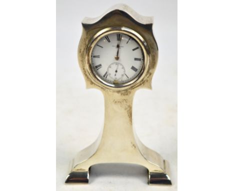 An Edwardian hallmarked silver pocket watch stand in the form of a bracket clock with shaped case and hinged back containing 