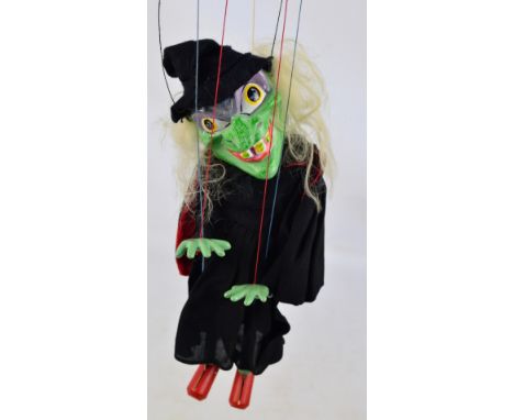 A boxed Pelham Puppet witch with wooden cross control.