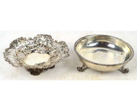 A Victorian hallmarked silver shaped circular dish with pierced and swag and foliate embossed motifs to the sides, raised on 