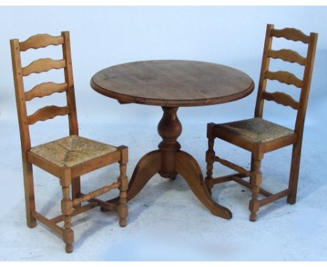 A circular modern pine table and four ladder back chairs (5).