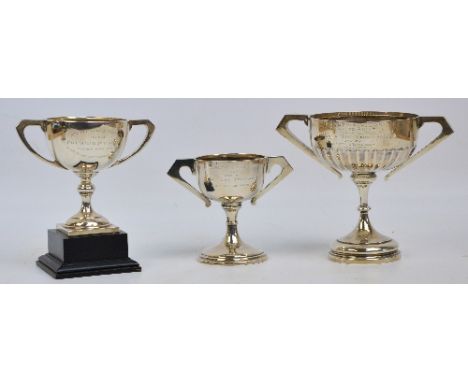 An Edward VIII hallmarked silver twin handled trophy cup with fluted decoration and presentation inscription, Walker & Hall, 