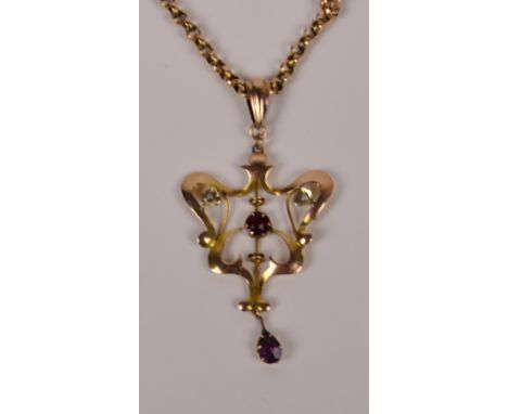 An Edwardian Art Nouveau style 9ct gold open work pendant set with ruby and amethyst coloured stones and two seed cultured pe