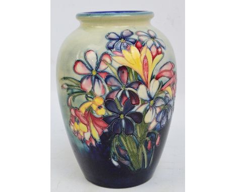 A Moorcroft "Spring Flowers" pattern tubeline decorated baluster vase on light and dark blue ground, impressed stamp mark wit