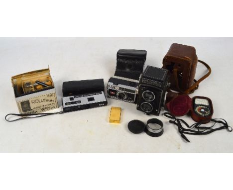 A cased Rolleicord camera with Franke & Heidecke double lens, a light meter, lighter etc.