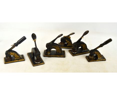 Six various japanned cast iron desk embossers for embossing circular company seals.