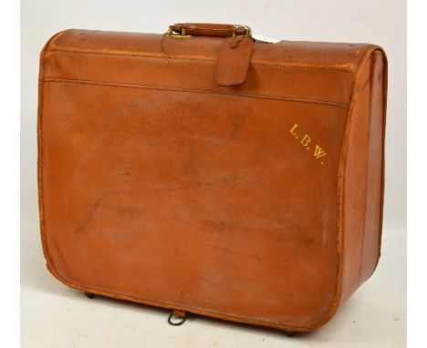 A vintage light brown leather suit carrier, with gilt initials "LBW" to one corner and a name tag attached to handle, 59 x 48