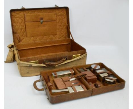 A c.1940 gentleman's leather travelling vanity case, the silk lined interior housing a pull-out folding tray containing vario