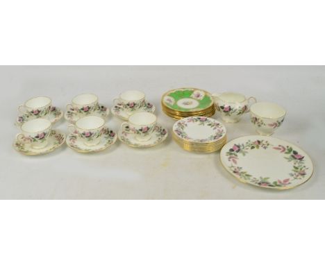 A part Wedgwood tea set in the "Hathaway Rose" pattern comprising six cups and saucers, seven plates, a jug and bowl, a sandw