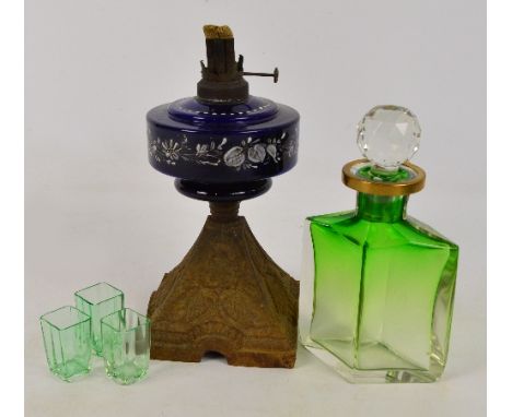 A green and clear glass decanter of lozenge form with brass mounted neck decorated with circular padlock, height 23.5cm inclu