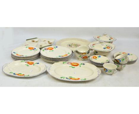 An Alfred Meakin part dinner service decorated with bright daisies on a cream ground comprising two serving platters, two lid