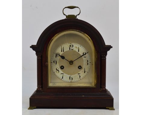 An early 20th Junghans eight day dome top mantel clock with arched silvered dial set with Arabic numerals on brass bracket fe