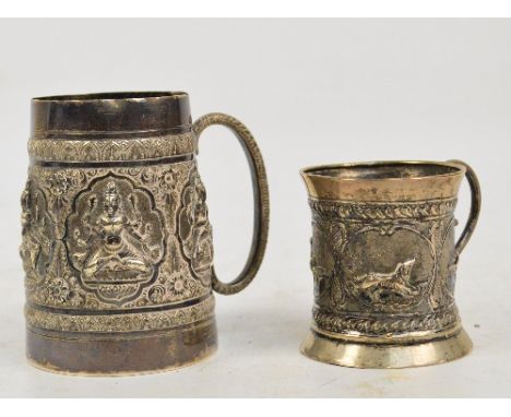 A c.1900 Indian white metal mug with embossed decoration and a smaller white metal cup of waisted form, decorated with animal