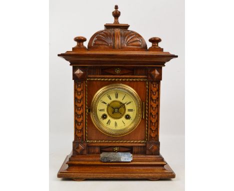 A c.1900 German Junghans walnut cased eight day mantel clock, the circular dial set with Roman numerals, with hallmarked silv