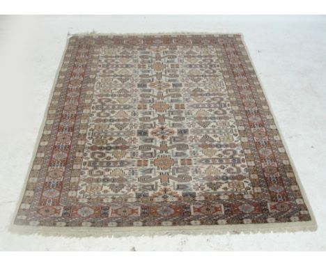 An Indian cream ground rug with all over device set main panel and stylised border.