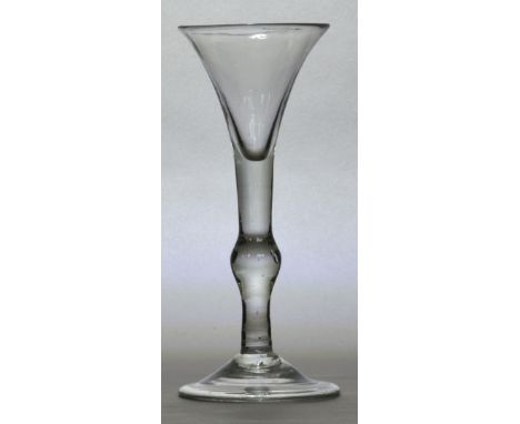 A mid 18th century light baluster wine glass with trumpet bowl above knopped stem and folded foot, English c.1730, height 18c