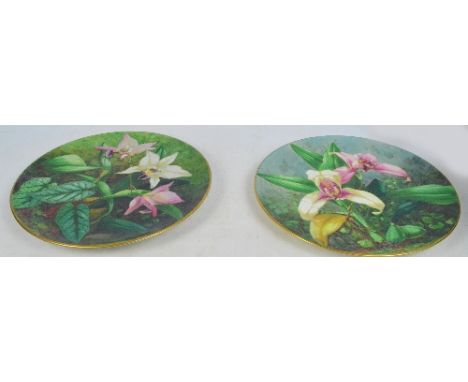 A pair of Royal Worcester chargers, later outside decorated with floral sprays and signed E. Stepman, both with puce printed 