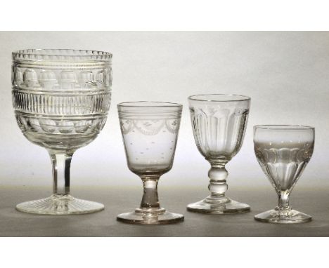 A very large mid 19th century cut glass goblet with horizontal bands of decoration to the rounded funnel bowl, hexagonal stem