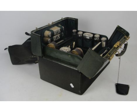 A fine Victorian travelling vanity case by Finnegans of Manchester, the canvas slip protecting the gilt line decorated green 