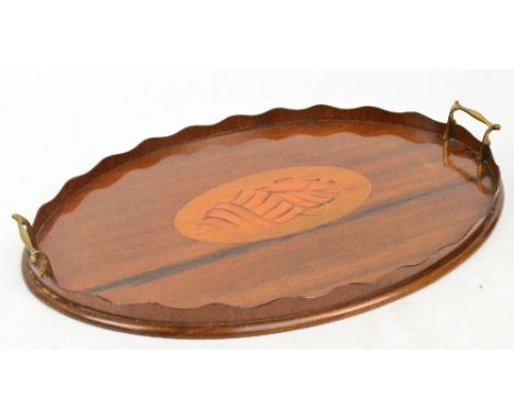 An Edwardian mahogany galleried twin handle tea tray centred with a large satinwood conch shell inlay, length 57cm.