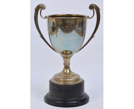 A George V hallmarked silver large trophy cup with winged twin handles, inscribed for "NCH Point to Point Races 1937", attach