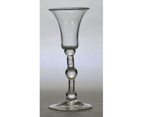 A mid 18th century glass with bell shaped bowl above bobbin turned stem and folded foot, English c.1750, height 16cm. CONDITI