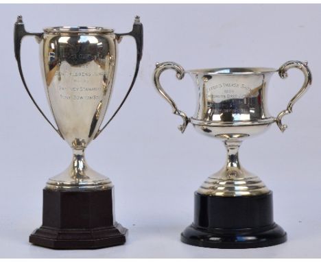 A George VI hallmarked silver trophy cup with scrolled handles and stepped circular base with presentation inscription, with 