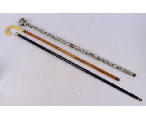 An early 20th century ebonised cane with a hallmarked silver knob, length 92cm, a walking stick set with mother of pearl pane