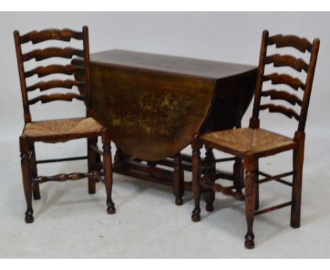 A Titchmarsh and Goodwin reproduction oak gateleg dropleaf dining table on turned and block supports, and four wavy ladder ba