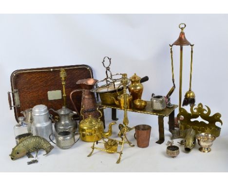 A collection of mixed metalware including brass tripod lamp bases, a pair of brass fish, a copper jug, a pewter tea service, 