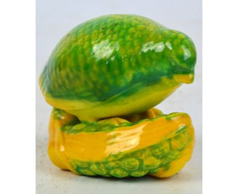 A Royal Worcester "Quail Upon Corn" netsuke, painted in shades of pale green and yellow/orange, black printed marks to base, 