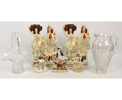 A pair of late Victorian Staffordshire flat back figure groups, each depicting a man holding a jug and a woman a bundle of ha