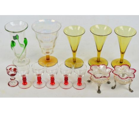 A small group of glass items comprising a pair of late Victorian clear glass open salts with ribbed ruby tinted rims on elect