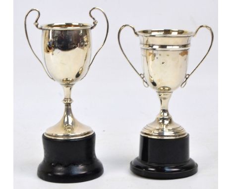 A George V hallmarked silver twin handled trophy cup without inscription, of plain design and knopped support, Charles Boyton