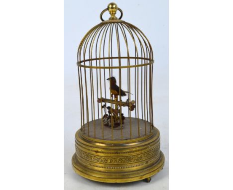 An early 20th century bird in a birdcage automaton, the bird with feathered plumage on foliate perch, the beak, head and tail