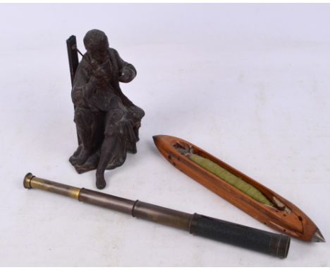 A small quantity of collectors' items comprising a spelter figure of a seated man, a money box, a small three draw telescope,