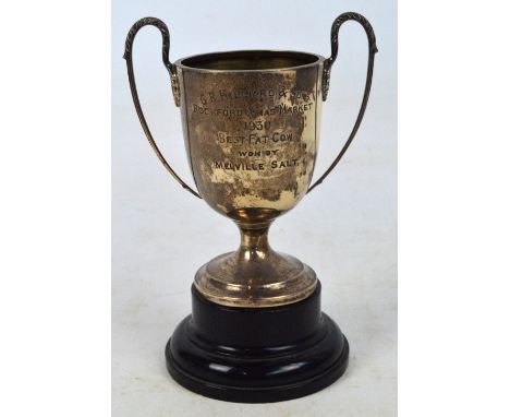 A George V hallmarked silver twin handled trophy cup of plain design with presentation inscription "G.B. Hilliard & Sons. Roc