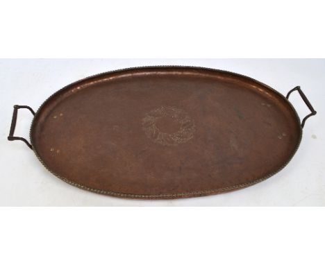 HUGH WALLIS (1871-1943); an Arts and Crafts oval copper twin handled tray with rope twist decorated rim engraved with a wreat
