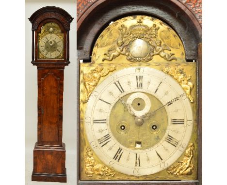 An 18th century walnut cased eight day longcase clock, the moulded domed hood above arched door with silvered chapter ring se