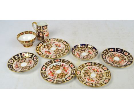 A group of Royal Crown Derby Imari pattern decorated items comprising a plate, diameter 18cm, five saucers in various sizes, 