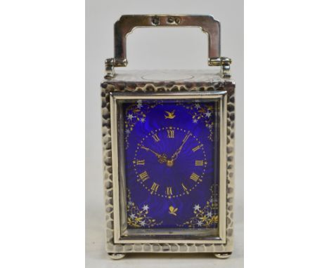 A late Victorian hallmarked silver carriage clock, the swing loop handle above hammered case and dark blue guilloche enamelle